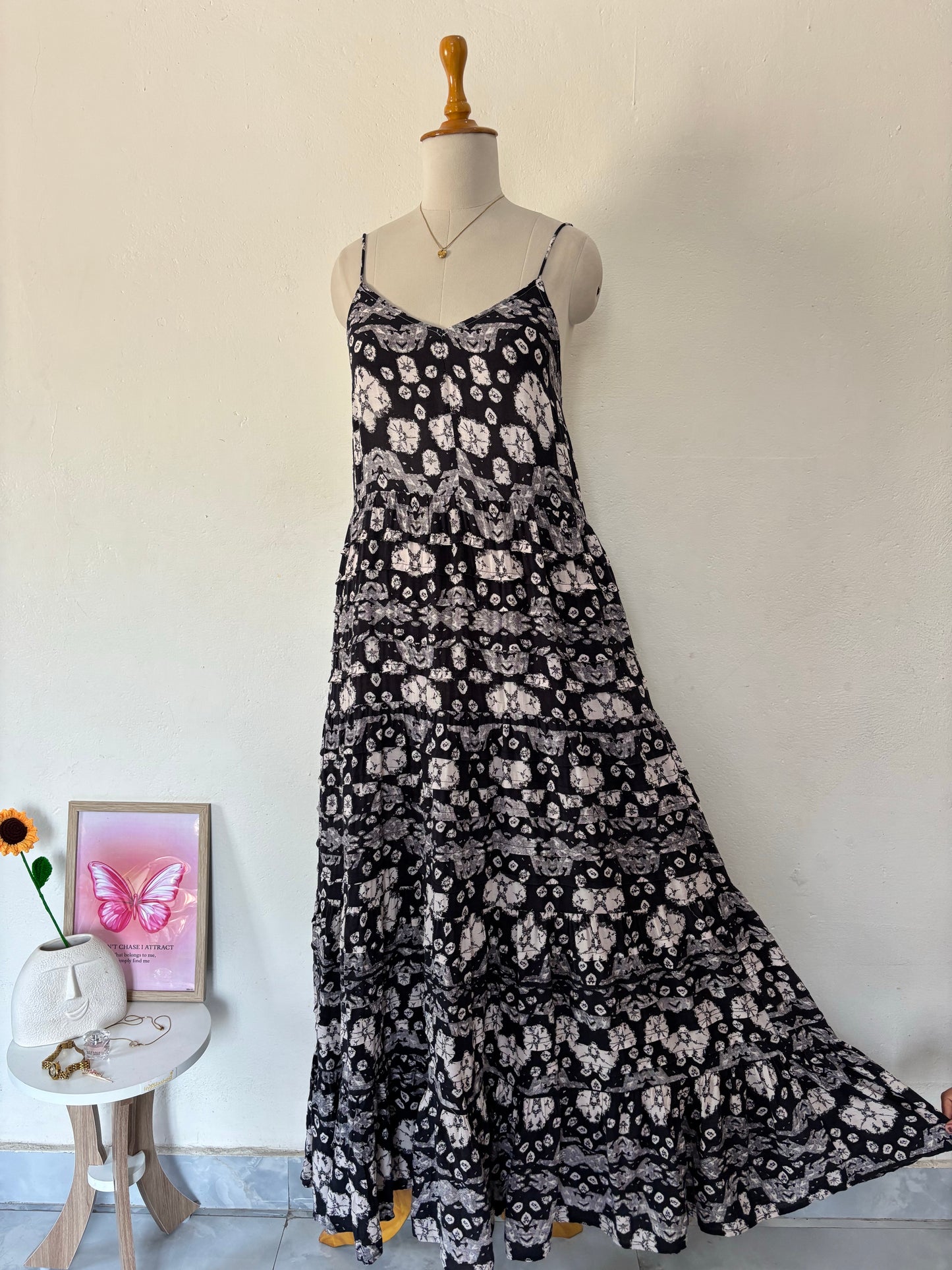 Black and white flared tiered maxi dress with adjustable tie up straps.