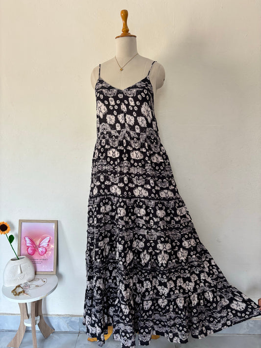 Black and white flared tiered maxi dress with adjustable tie up straps.