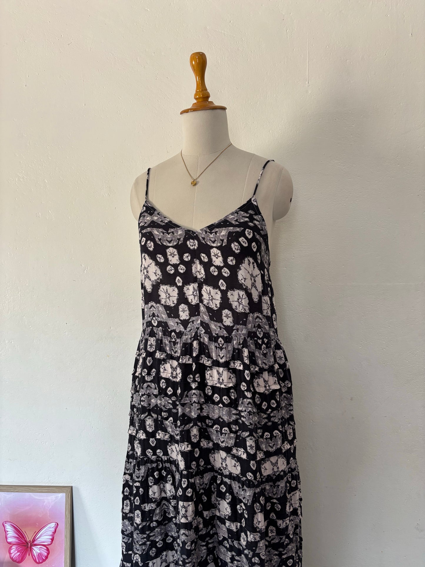 Black and white flared tiered maxi dress with adjustable tie up straps.