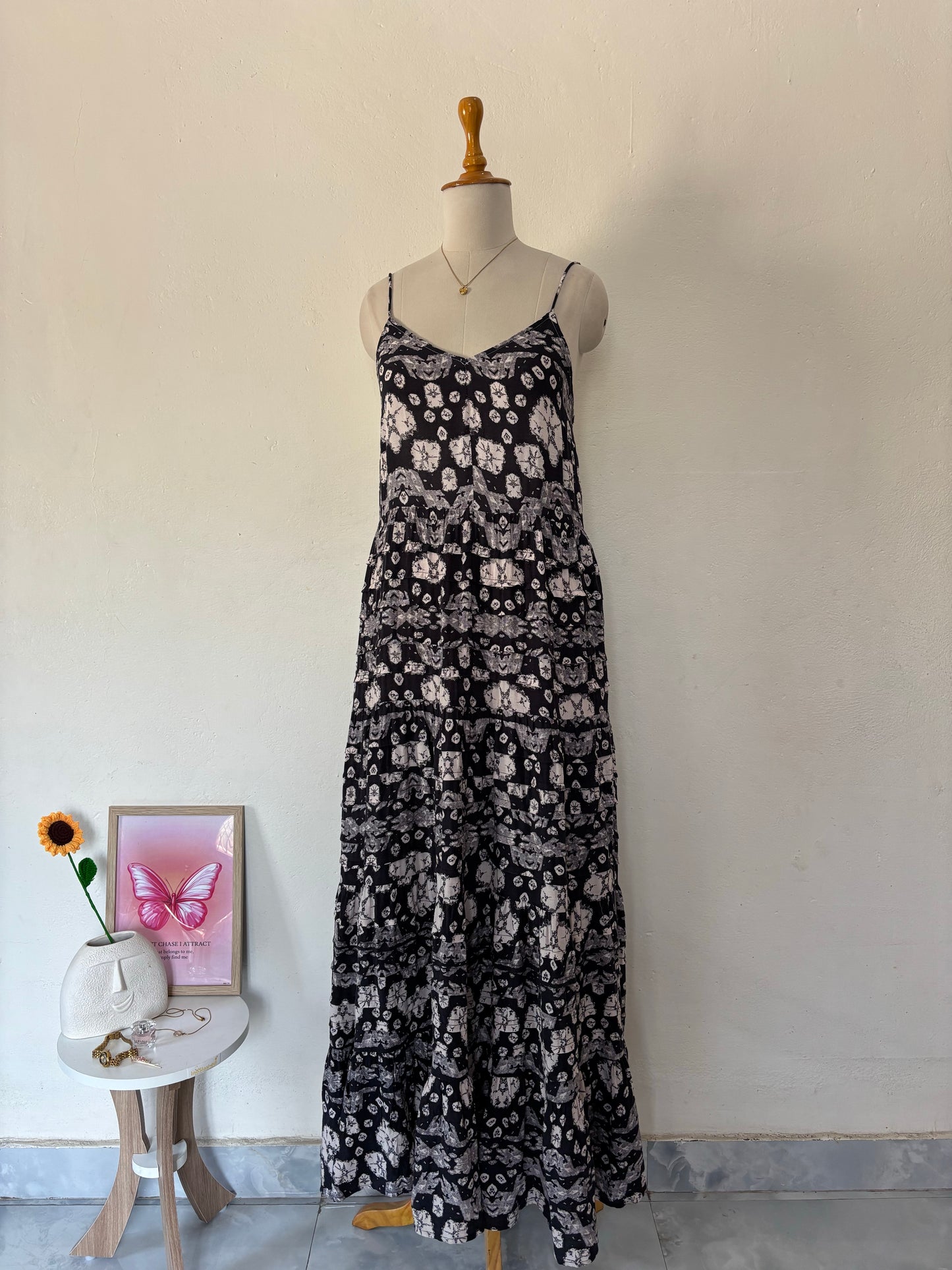 Black and white flared tiered maxi dress with adjustable tie up straps.