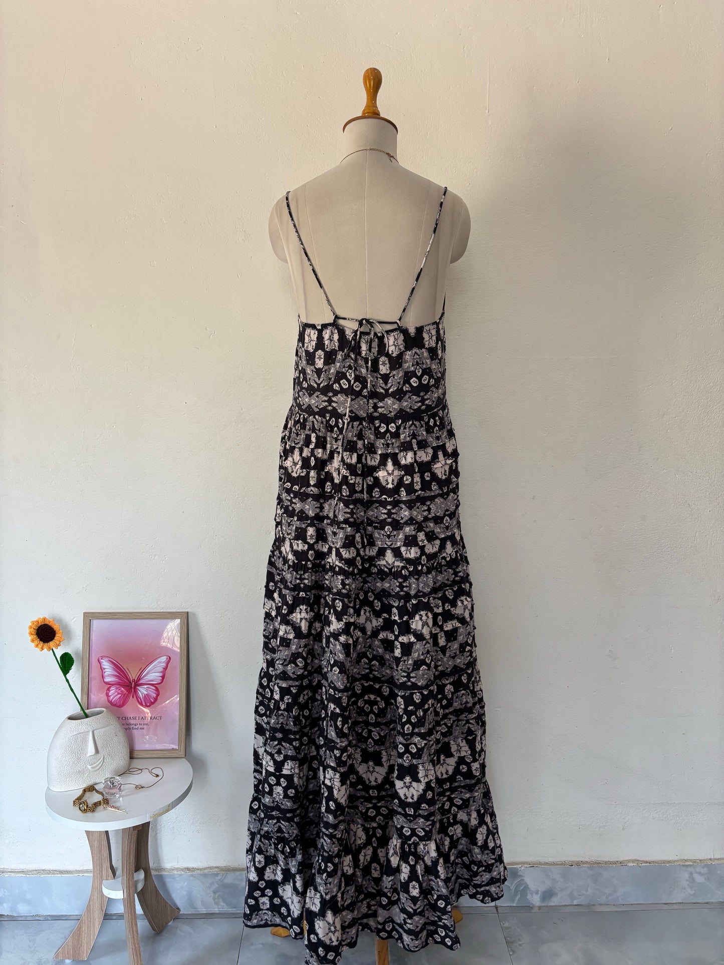 Black and white flared tiered maxi dress with adjustable tie up straps.